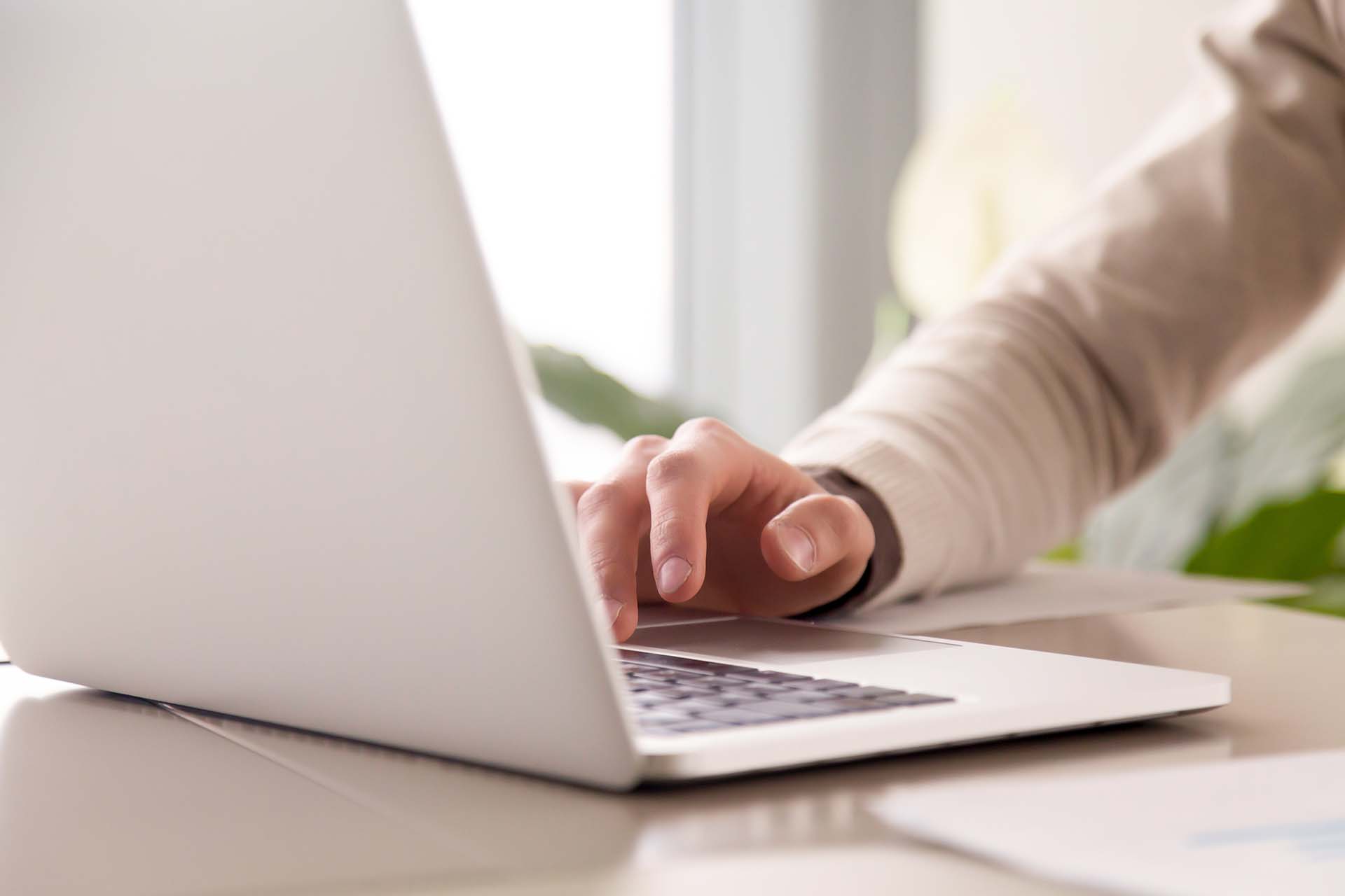 Close up of businessman working on laptop computer at office